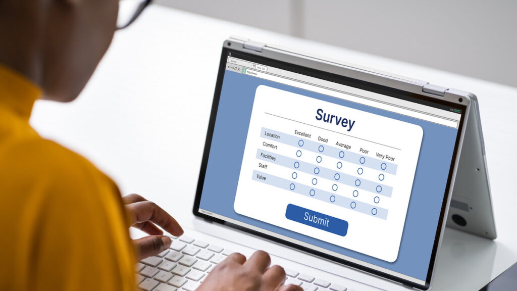 A resident completing an online survey on a laptop, representing multifamily residents' voices across key satisfaction categories.